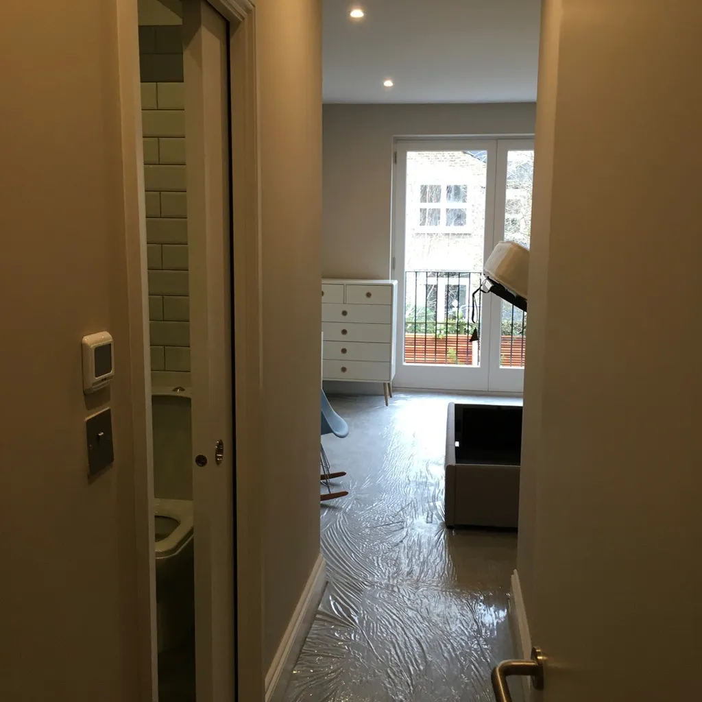 Hallway of a finished flat looking through to the living space and Juliet balcony