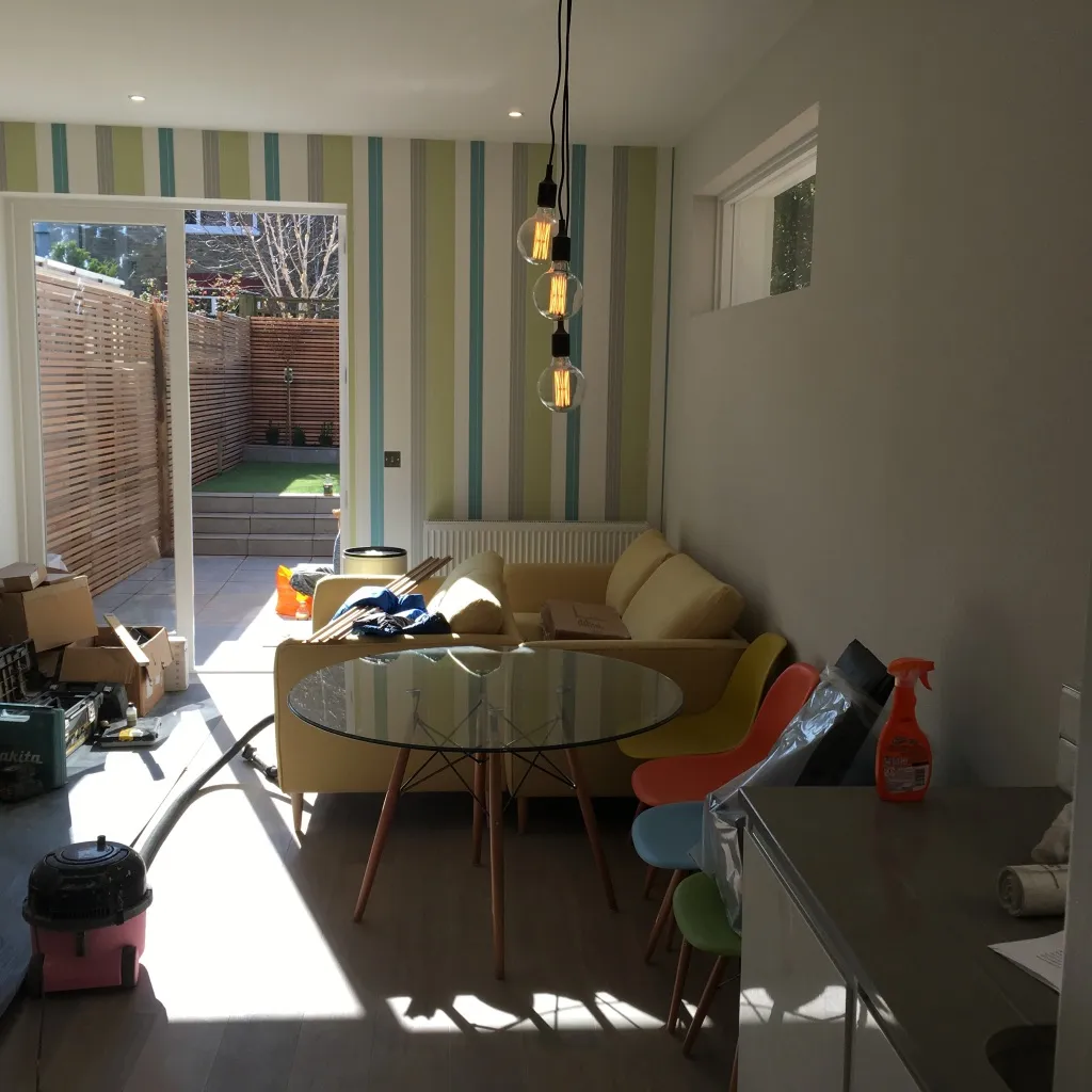 Dining and living area of the ground-floor flat with doors opening onto the private garden