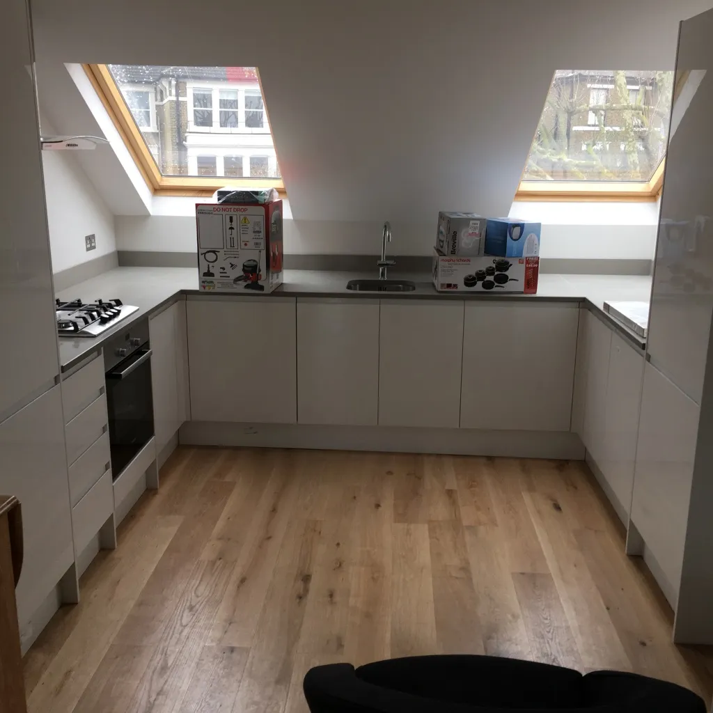 Finished kitchen in the top-floor flat, lit by two large rooflights