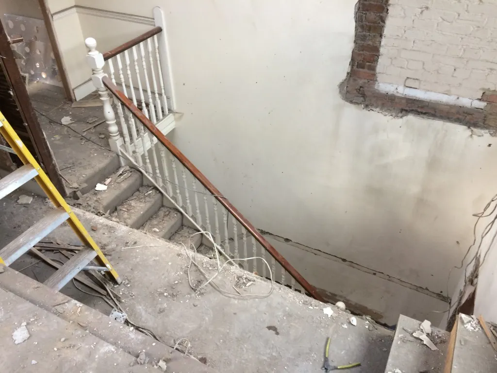 Original stairwell stripped back to brick during the conversion of a Clapham house into flats