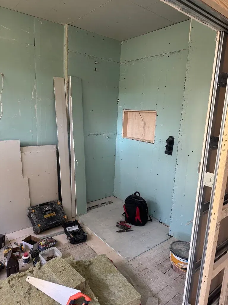Tanking boards installed in the new bathroom before tiling, waterproofing the wet area