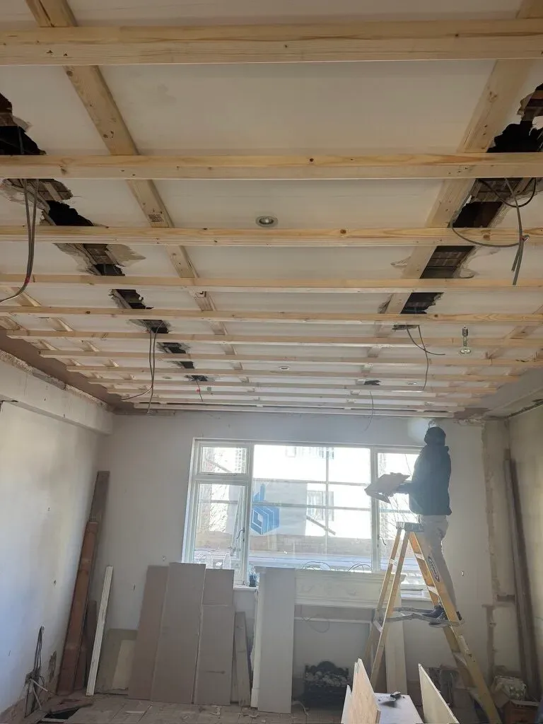 Ceiling opened up to expose the joists for rewiring during the whole-house renovation