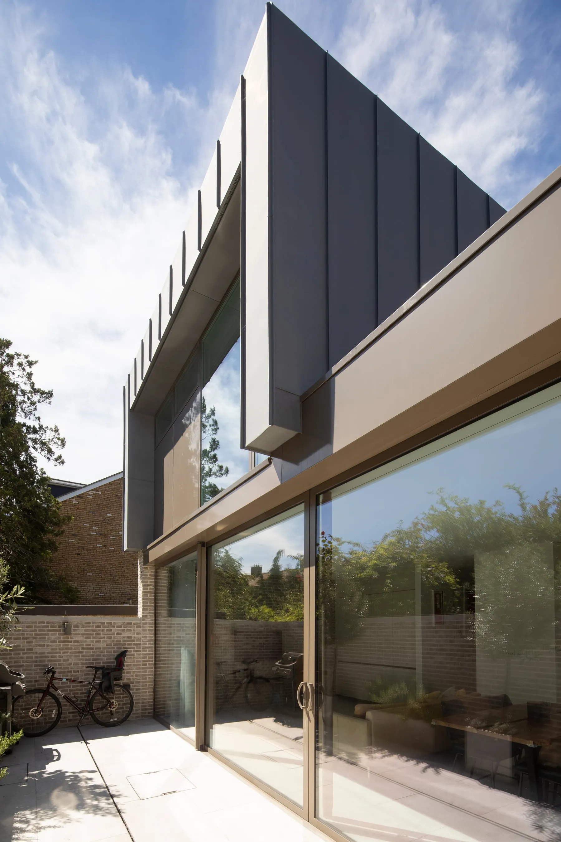 Contemporary residential extension in South West London with zinc cladding and structural glazing
