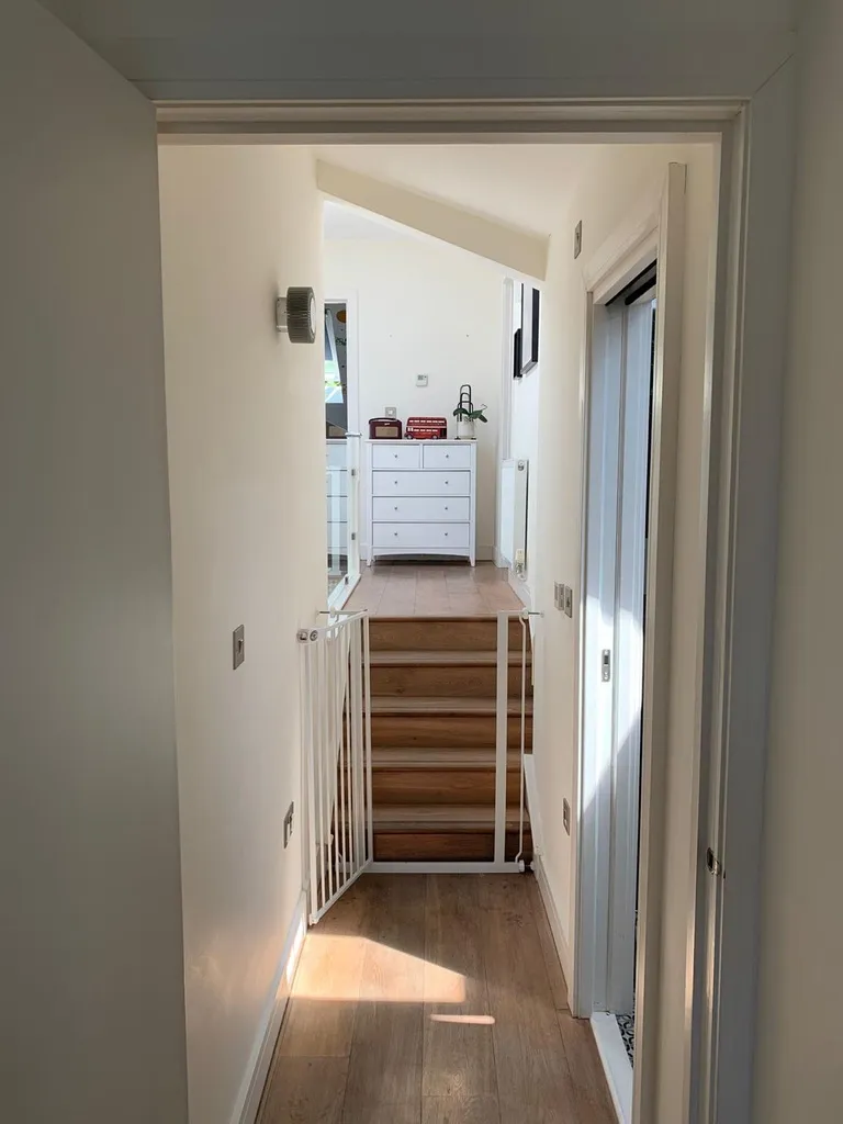 Finished hallway and new staircase leading up to the converted loft