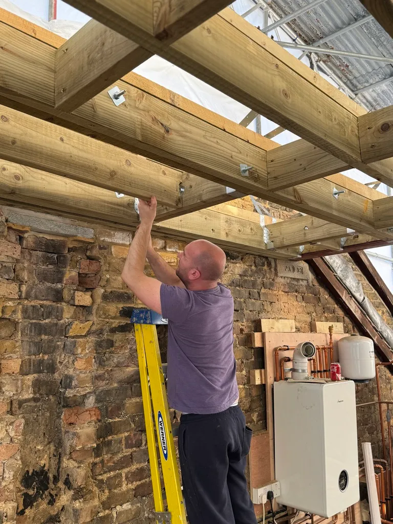 New floor joists being fixed in place during a loft conversion in Wandsworth