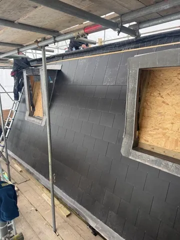 New slate roof laid over the loft conversion with dormer and rooflight openings formed