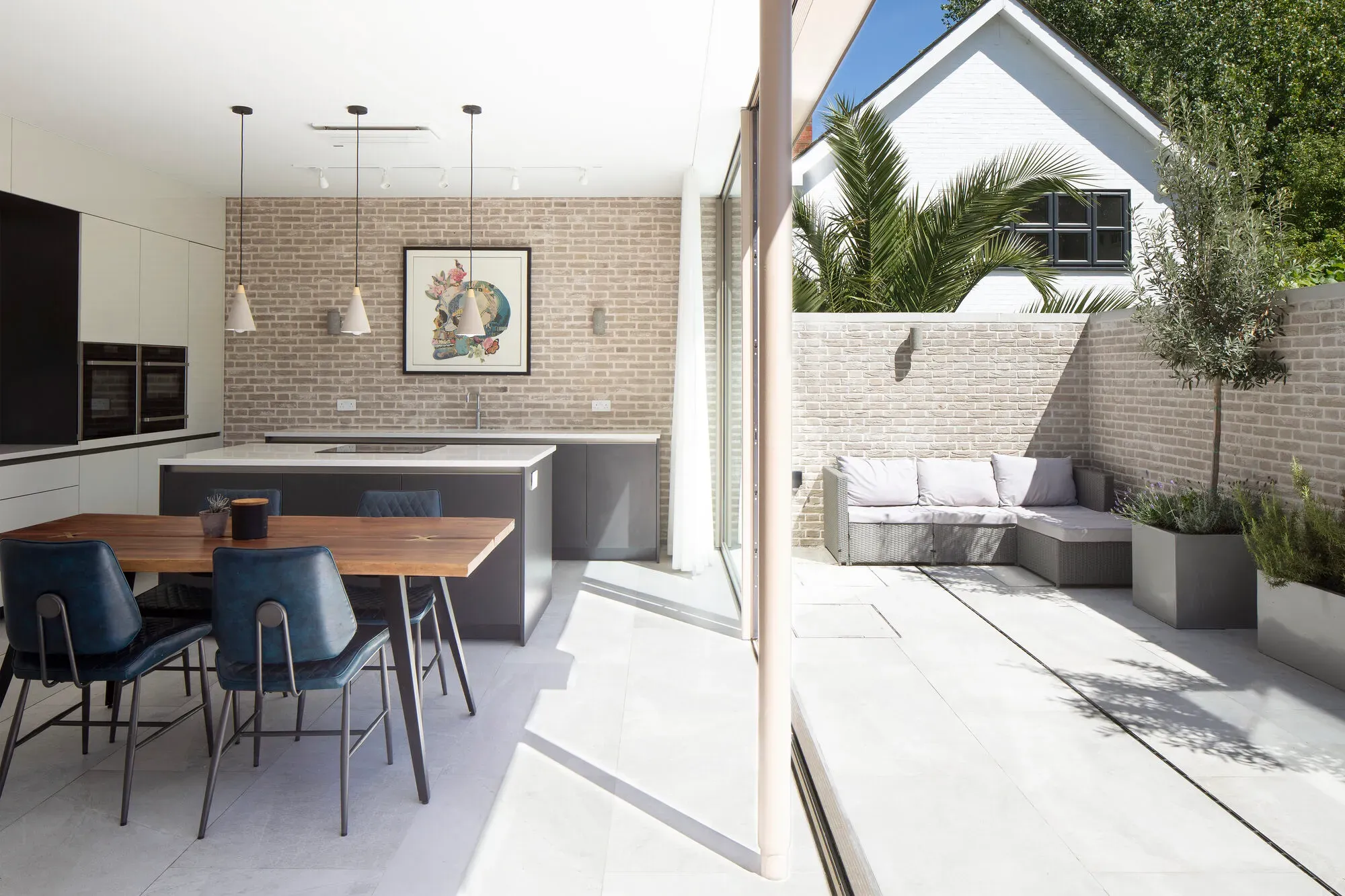 Finished open-plan kitchen and dining space opening onto the garden of a new-build house in Wandsworth