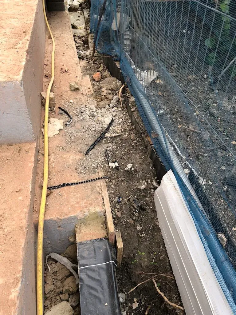 Below-ground drainage set out across the groundworks before the slab was poured