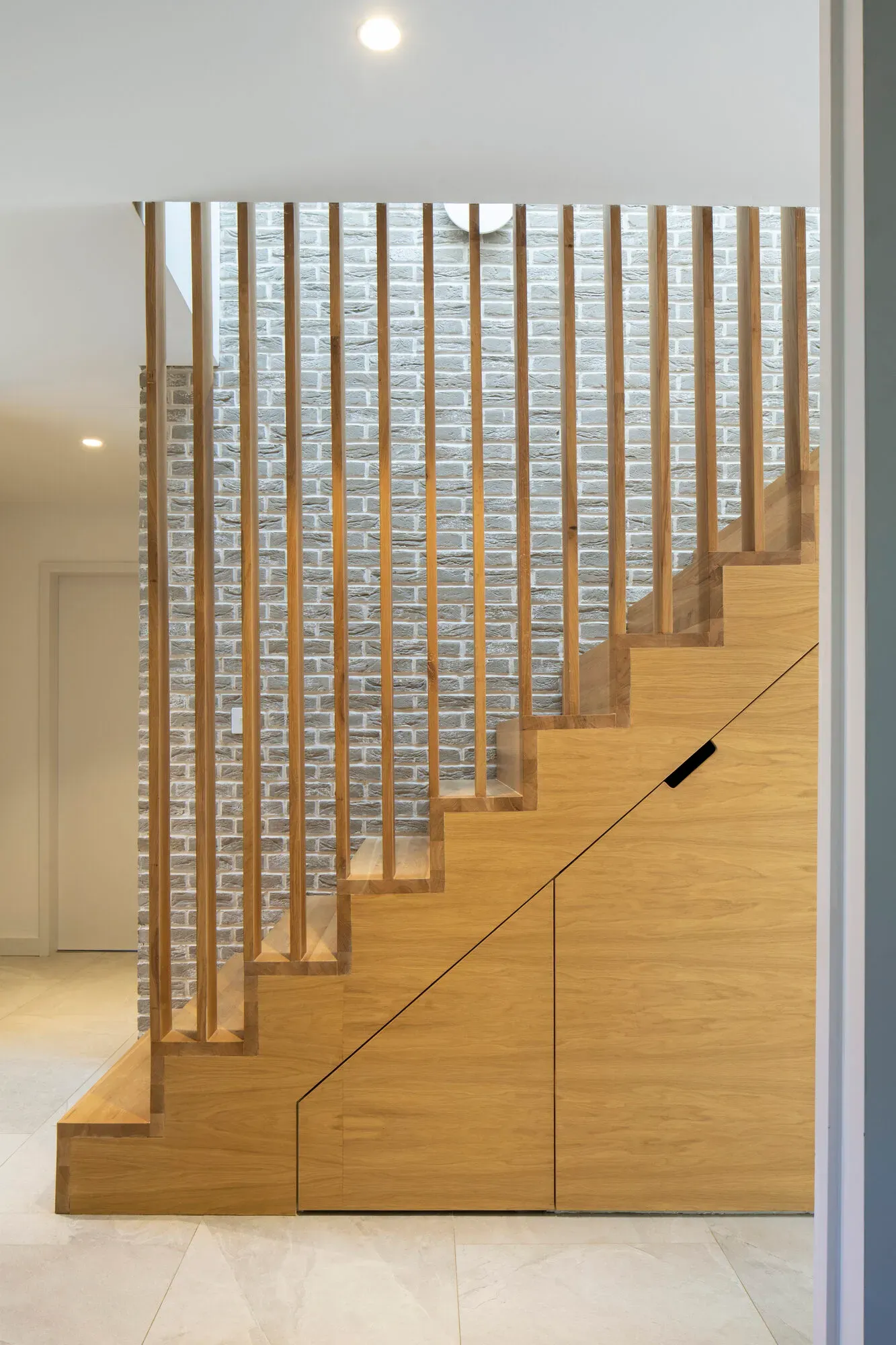 Bespoke oak staircase and timber screen in the completed new-build house